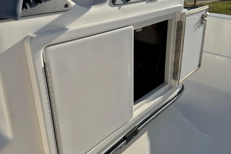 Slide: The Image of Open storage compartment on a 2015 Epic 22 Sport Console boat. - 19