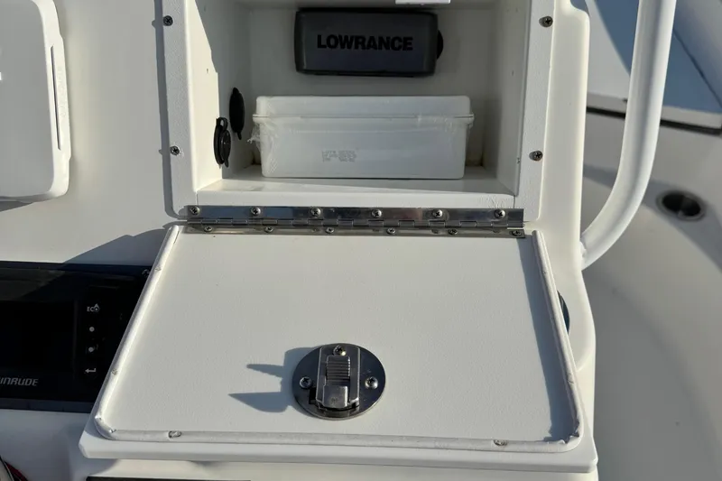 Slide: The Image of Open storage compartment on 2015 Epic 22 Sport Console boat with Lowrance device. - 22