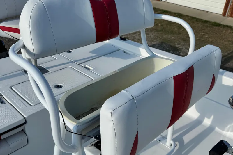 Slide: The Image of 2015 Epic 22 Sport Console boat seat with red and white upholstery and storage compartment. - 23