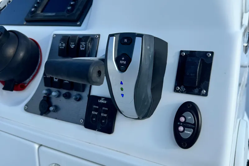 Slide: The Image of Control panel of a 2015 Epic 22 Sport Console boat with throttle and switches. - 24