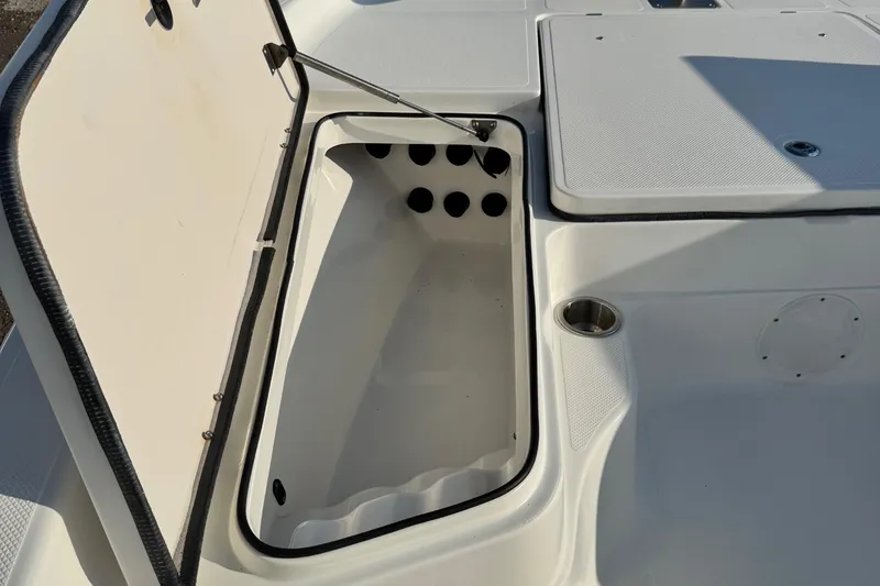 Slide: The Image of Open storage compartment on a 2015 Epic 22 Sport Console boat. - 27