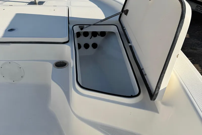 Slide: The Image of Open storage compartment on 2015 Epic 22 Sport Console boat deck. - 28