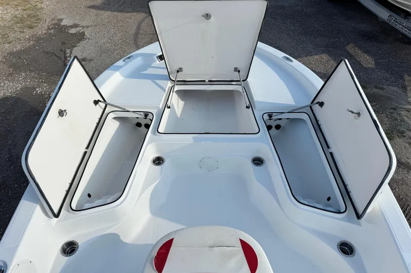 Slide: The Image of Open storage compartments on a 2015 Epic 22 Sport Console boat deck. - 29