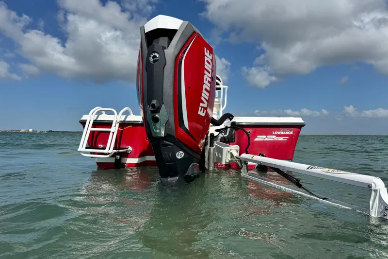 Slide: The Image of 2015 Epic 22 Sport Console boat with Evinrude engine in calm waters. - 3