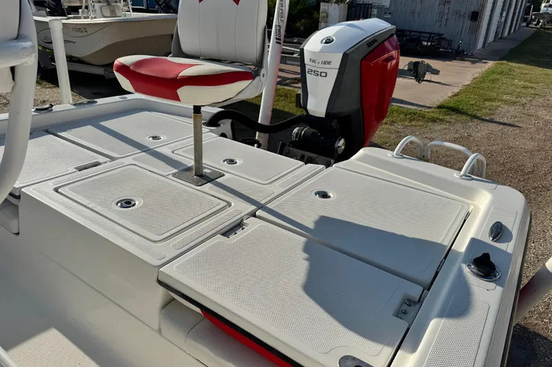 Slide: The Image of 2015 Epic 22 Sport Console boat with Evinrude 250 engine, featuring red and white seating. - 35