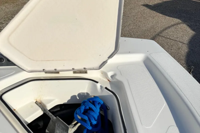 Slide: The Image of Open storage compartment on 2015 Epic 22 Sport Console boat with blue rope and anchor. - 36