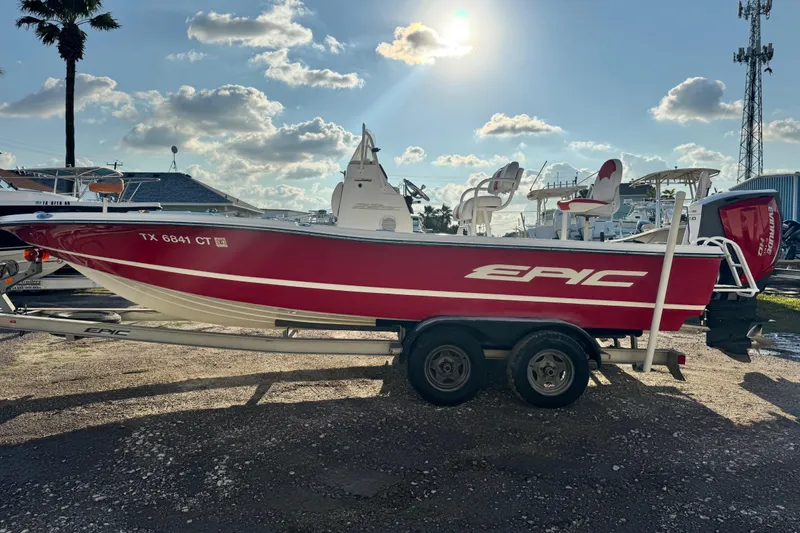 Slide: The Image of 2015 Epic 22 Sport Console boat on trailer, red and white design, sunny day. - 4