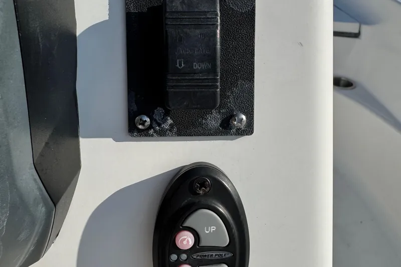 Slide: The Image of Control panel on a 2015 Epic 22 Sport Console boat, featuring switches and buttons. - 43