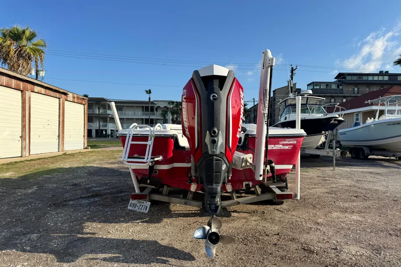 Slide: The Image of 2015 Epic 22 Sport Console boat with Evinrude engine, parked outdoors. - 5