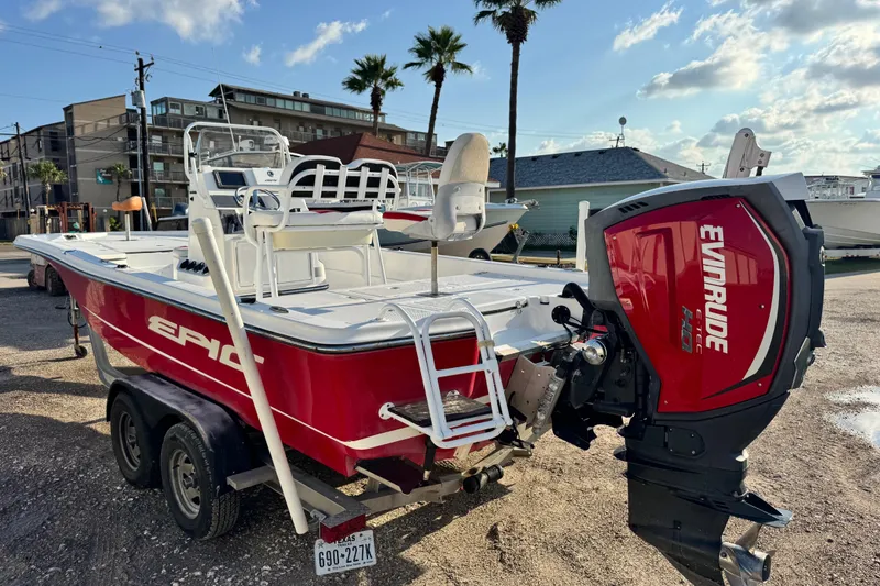 Slide: The Image of 2015 Epic 22 Sport Console boat with Evinrude engine, parked on a trailer. - 8