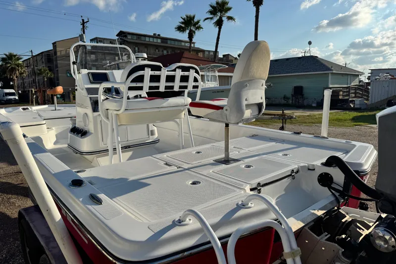 Slide: The Image of 2015 Epic 22 Sport Console boat with seating, docked under a sunny sky. - 9