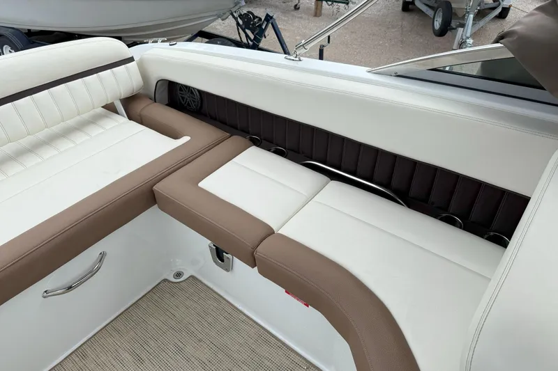 Slide: The Image of 2016 Cobalt 26SD boat interior with white and brown cushioned seating. - 12