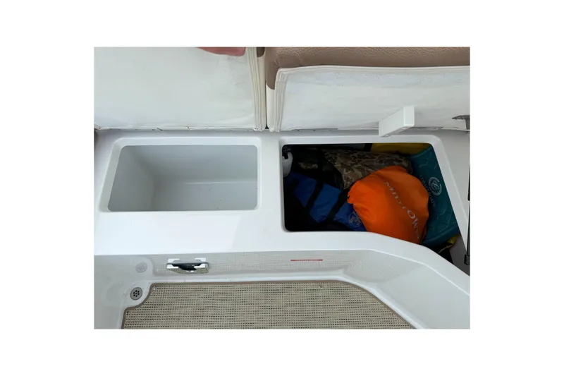 Slide: The Image of 2016 Cobalt 26SD boat storage compartments with life jackets and gear. - 18