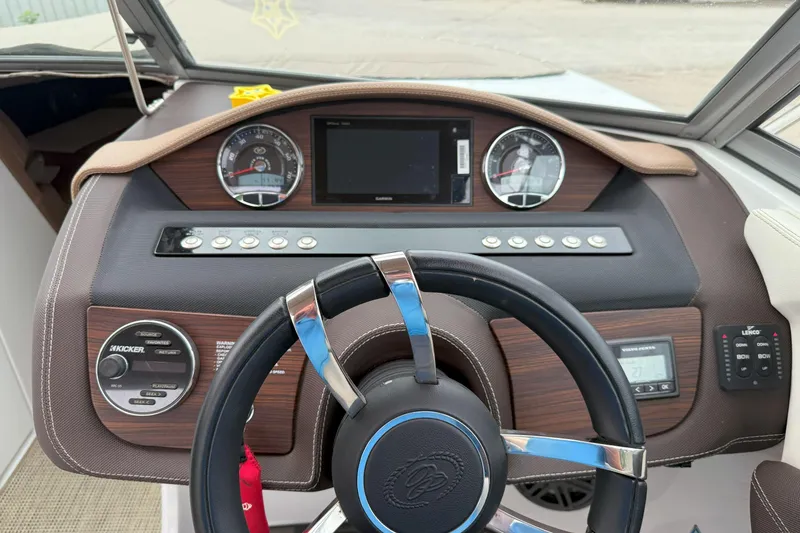Slide: The Image of Dashboard of a 2016 Cobalt 26SD boat with steering wheel and control panel. - 22