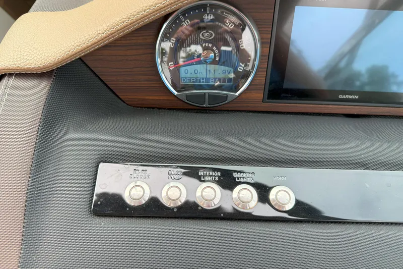Slide: The Image of Dashboard of a 2016 Cobalt 26SD boat with gauges and control buttons. - 27
