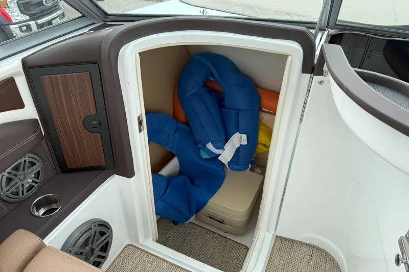 Slide: The Image of 2016 Cobalt 26SD boat storage compartment with life jackets and speakers. - 31