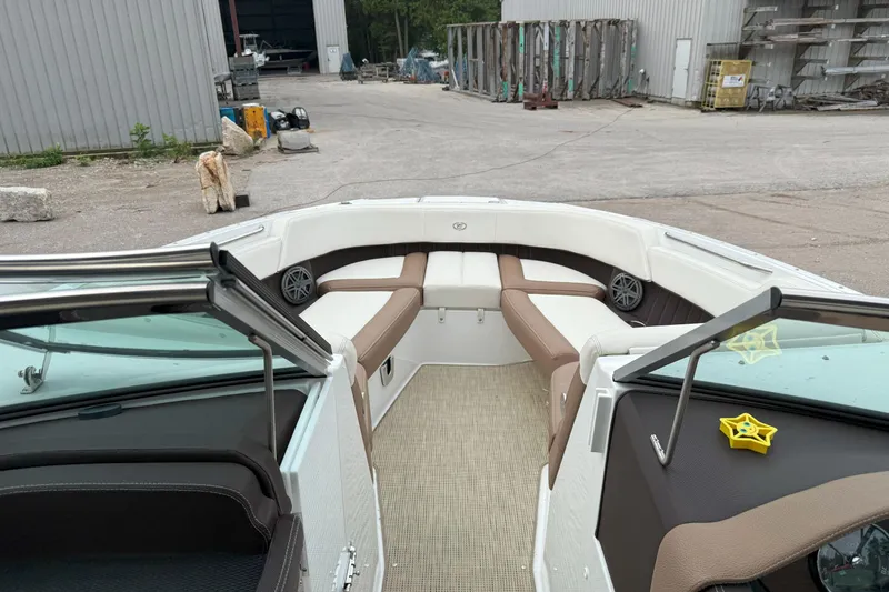 Slide: The Image of 2016 Cobalt 26SD boat interior with beige seating and open bow design. - 32