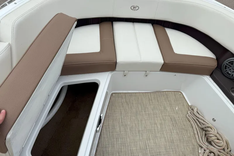 Slide: The Image of 2016 Cobalt 26SD boat interior with storage compartment and cushioned seating. - 37