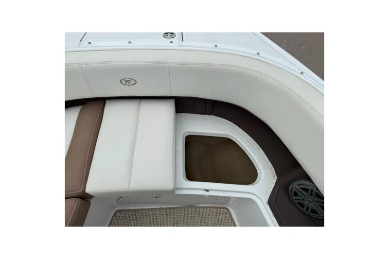 Slide: The Image of 2016 Cobalt 26SD boat interior with white and brown seating and storage compartment. - 39