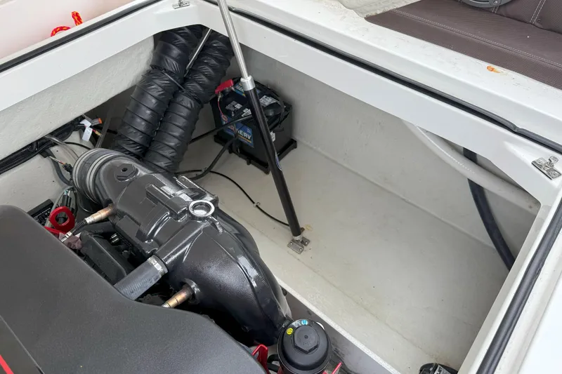 Slide: The Image of Engine compartment of a 2016 Cobalt 26SD boat, showing mechanical components and battery. - 42