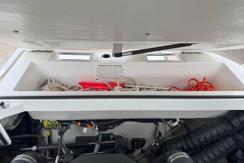 Slide: The Image of Open storage compartment in 2016 Cobalt 26SD boat with ropes and equipment. - 43
