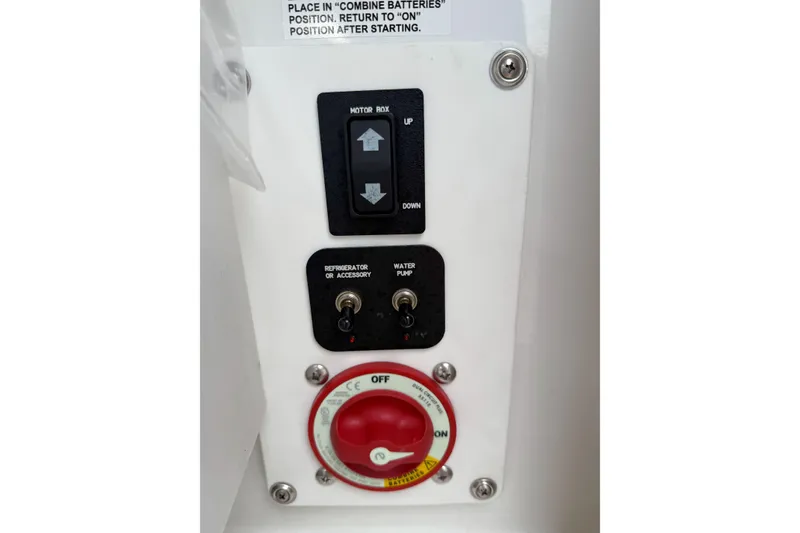 Slide: The Image of Control panel of a 2016 Cobalt 26SD boat with switches and battery dial. - 44