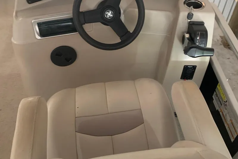 Slide: The Image of 2012 Sweetwater 2086 boat interior with steering wheel and control panel. - 10