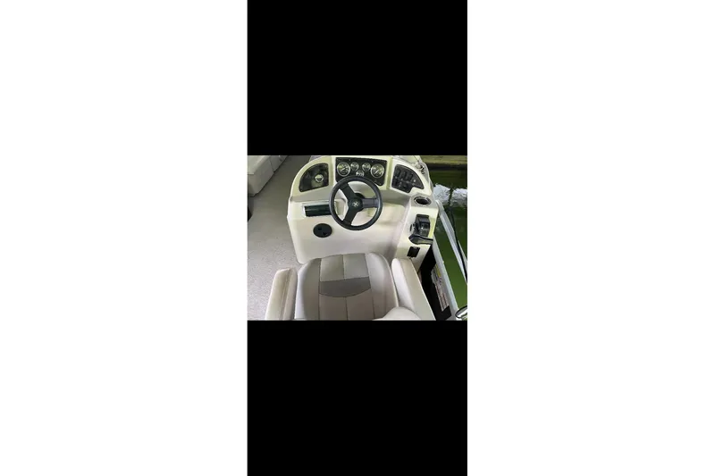 Slide: The Image of Steering console of a 2012 Sweetwater 2086 boat with gauges and controls. - 18