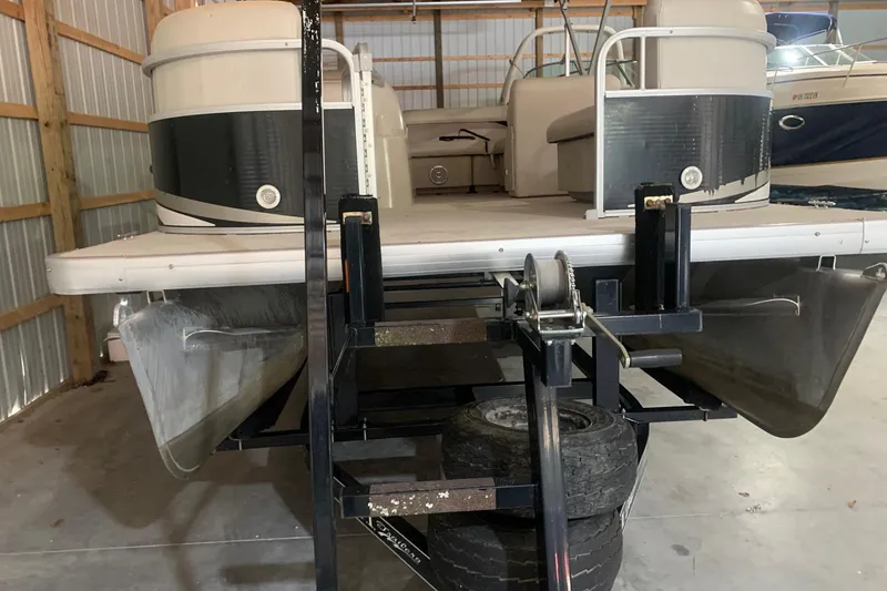 Slide: The Image of 2012 Sweetwater 2086 pontoon boat on trailer in storage facility. - 2