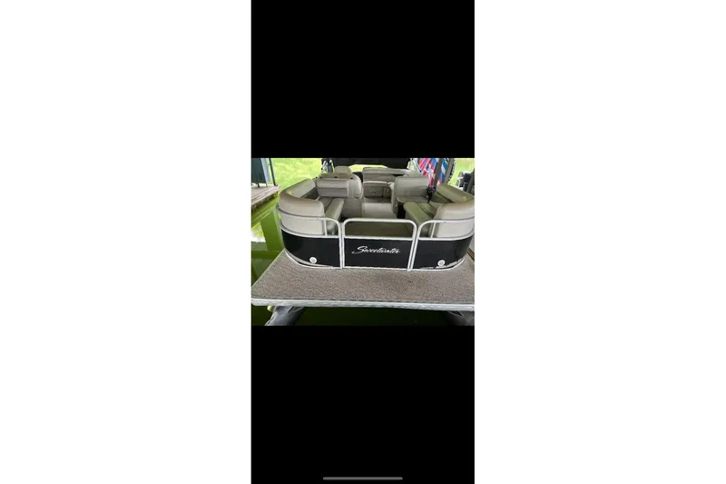Slide: The Image of 2012 Sweetwater 2086 pontoon boat with beige seating and black exterior. - 20