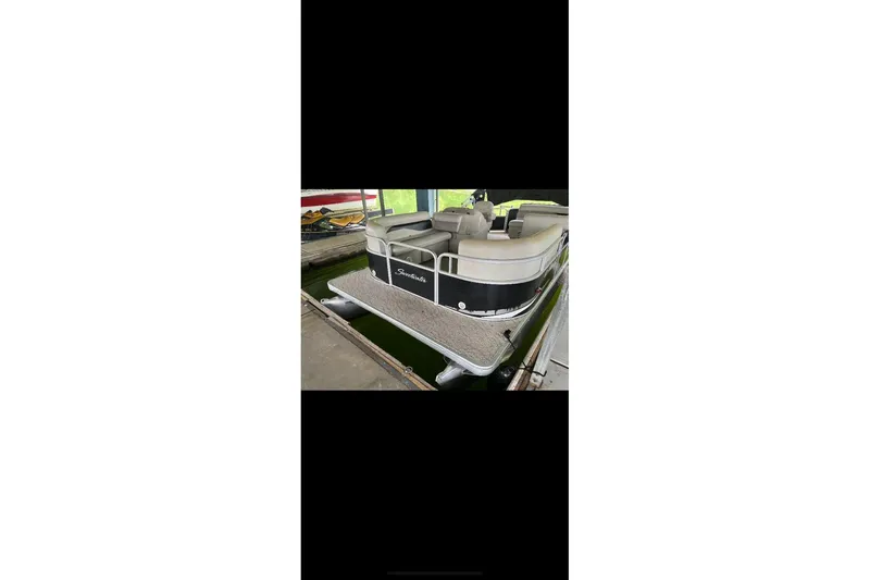 Slide: The Image of 2012 Sweetwater 2086 pontoon boat docked, featuring comfortable seating and sleek design. - 21