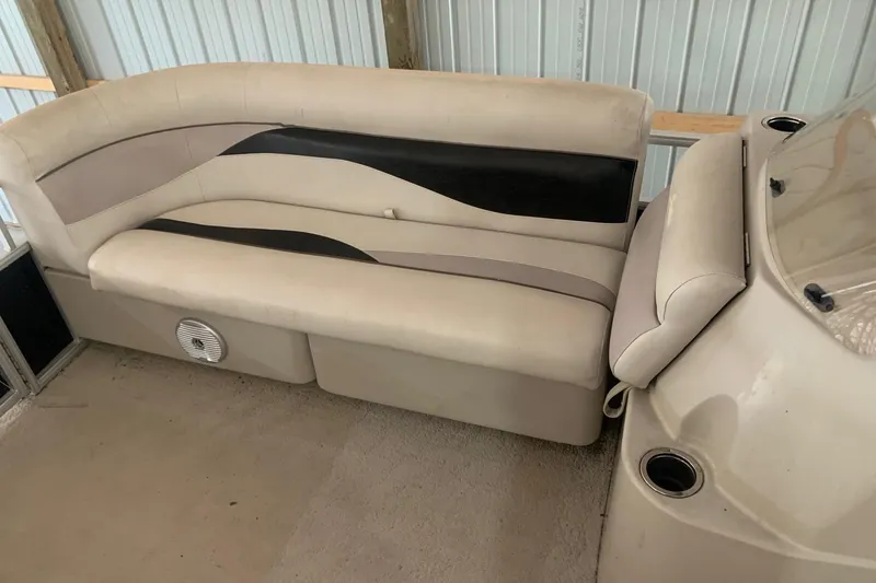 Slide: The Image of 2012 Sweetwater 2086 boat interior with beige and black seating. - 5