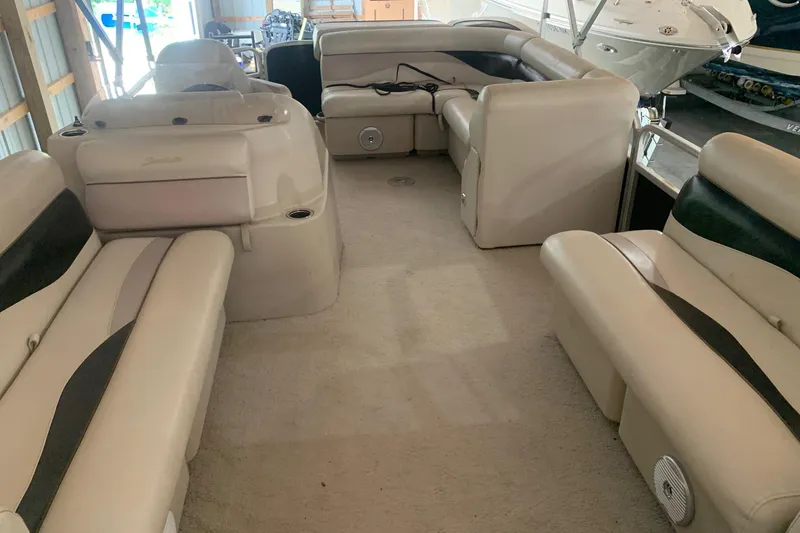 Slide: The Image of Interior of a 2012 Sweetwater 2086 pontoon boat with beige seating and carpet. - 7