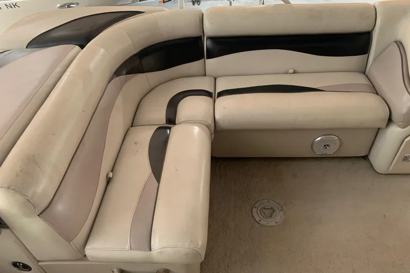 Slide: The Image of 2012 Sweetwater 2086 boat interior with beige and black seating. - 8