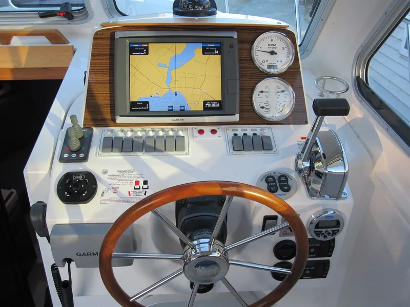 Slide: The Image of Helm of 2011 Back Cove 30 boat with GPS, gauges, and wooden steering wheel. - 15