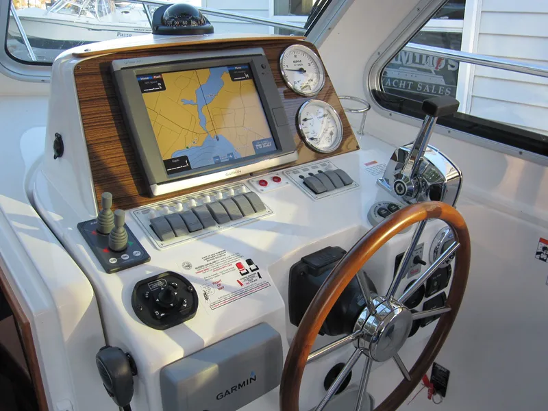 Slide: The Image of Helm of 2011 Back Cove 30 boat with Garmin navigation system and wooden steering wheel. - 16
