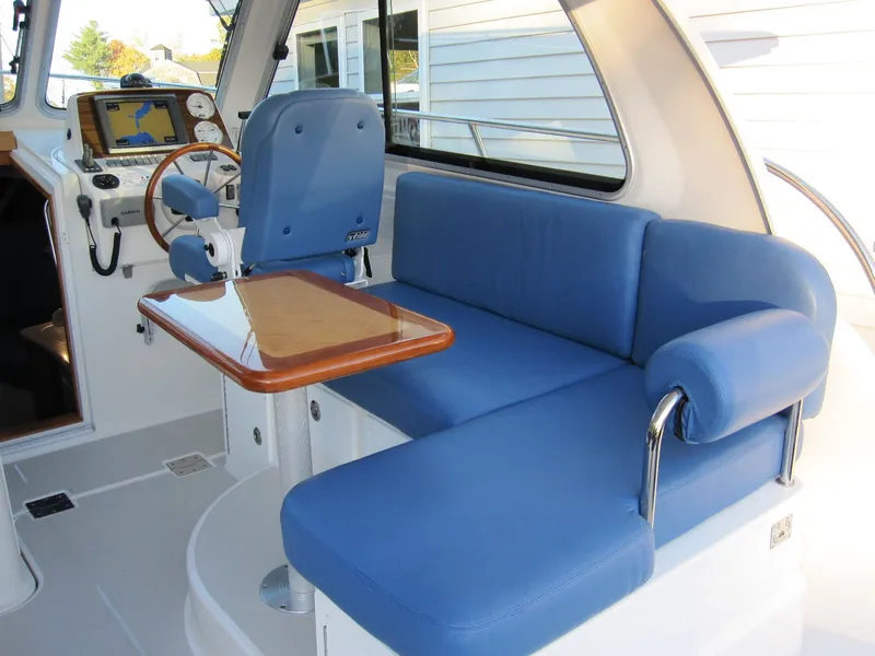 Slide: The Image of 2011 Back Cove 30 interior with blue seating and wooden table. - 21