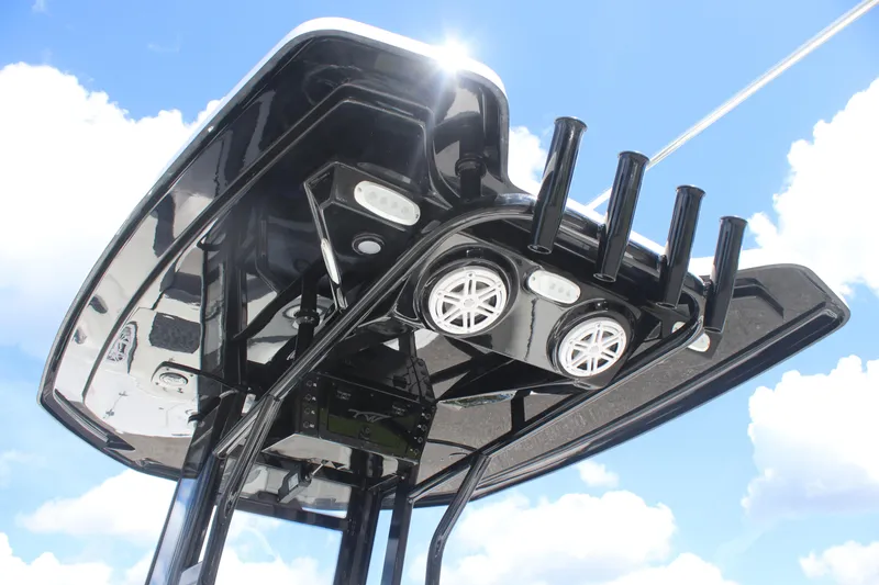 Slide: The Image of 2026 Tidewater 232 LXF boat top view with speakers and rod holders against blue sky. - 13