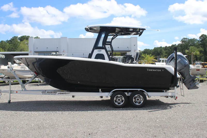 Slide: The Image of 2026 Tidewater 232 LXF boat on trailer, parked outdoors under blue sky. - 5