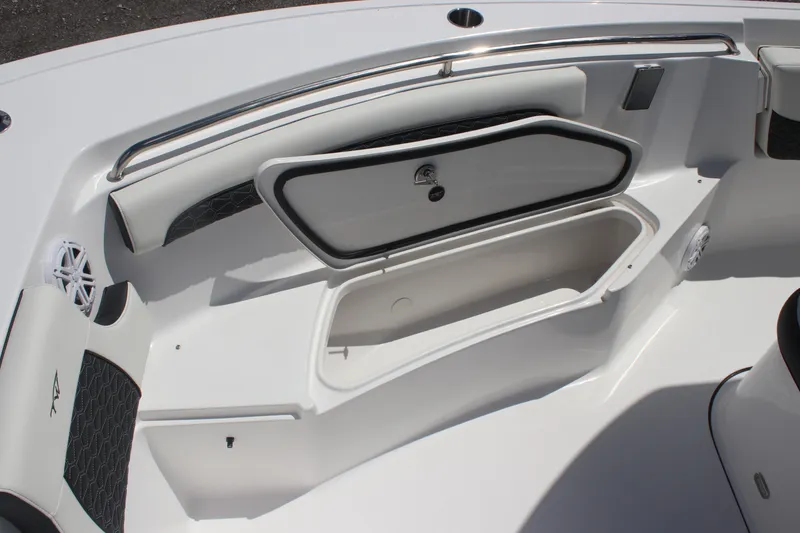 Slide: The Image of 2026 Tidewater 232 LXF boat interior with open storage compartment and cushioned seating. - 6