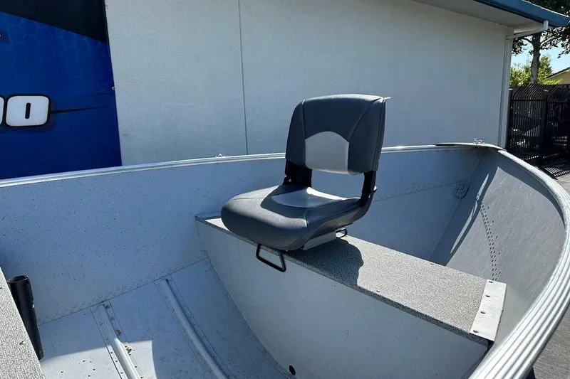 Slide: The Image of 2024 Lund WC-14 boat interior with a single gray seat. - 8