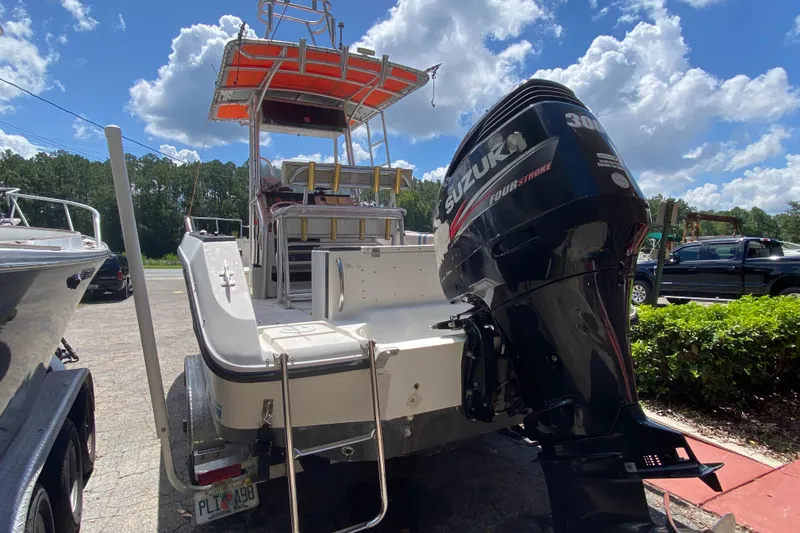 Slide: The Image of 1988 Sea Ray Laguna 24 boat with Suzuki 300 outboard motor, parked outdoors. - 3
