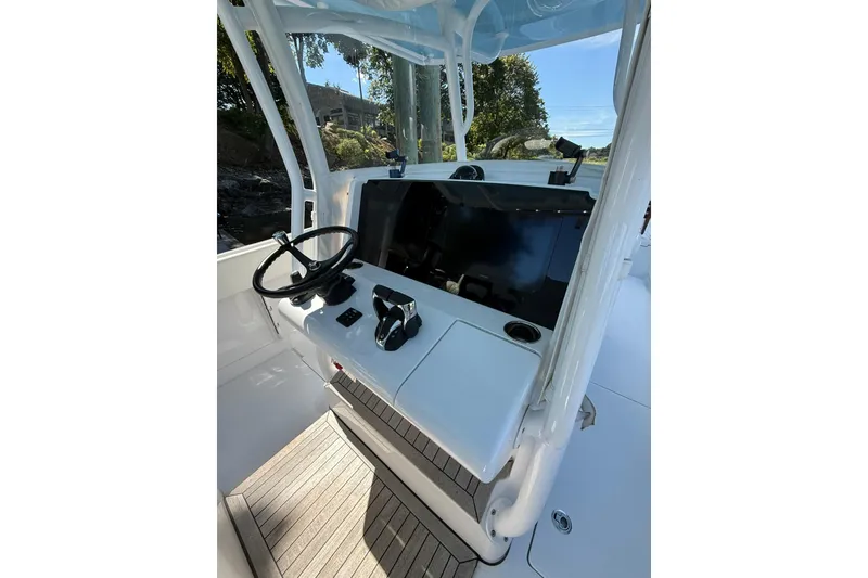 Slide: The Image of 2021 Jupiter 38 HFS boat helm with steering wheel and control panel. - 11
