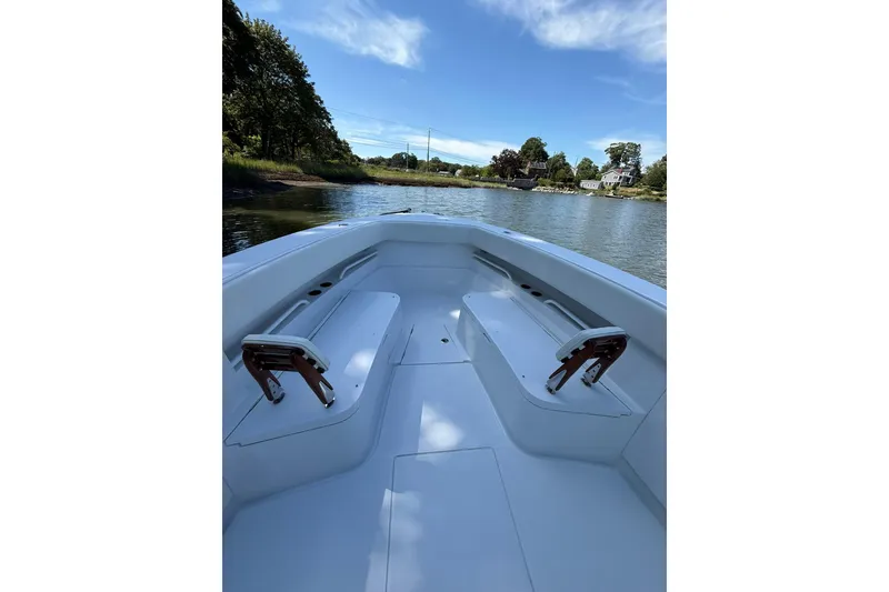 Slide: The Image of 2021 Jupiter 38 HFS boat interior with seating, on a calm river under blue sky. - 14