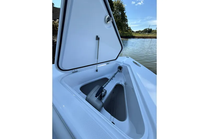 Slide: The Image of Open anchor compartment on 2021 Jupiter 38 HFS boat by the water. - 20