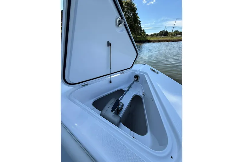 Slide: The Image of Open anchor compartment on 2021 Jupiter 38 HFS boat by the water. - 21