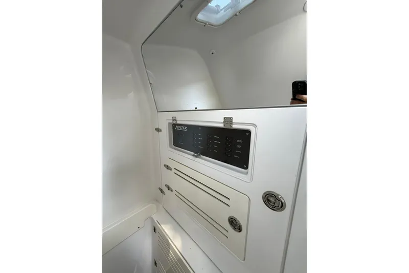 Slide: The Image of Interior view of 2021 Jupiter 38 HFS boat control panel and storage compartments. - 23