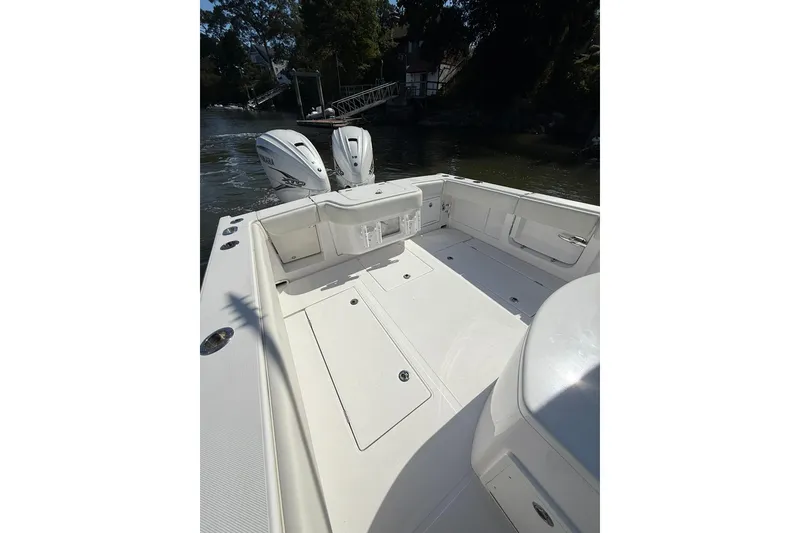 Slide: The Image of 2021 Jupiter 38 HFS boat with dual outboard engines, spacious deck, and sleek design. - 27