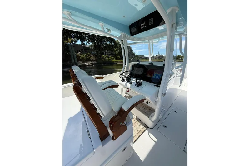 Slide: The Image of 2021 Jupiter 38 HFS boat interior with helm, dual seats, and navigation display. - 28