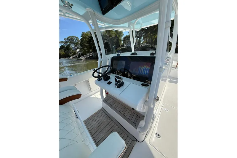 Slide: The Image of 2021 Jupiter 38 HFS boat helm with modern controls and navigation display. - 30